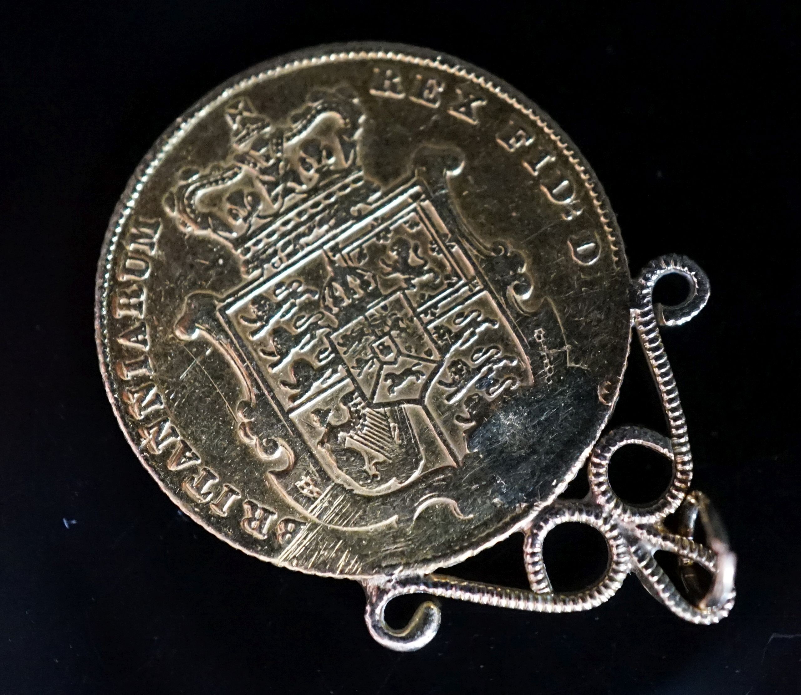 A George IV 1829 sovereign, now with pendant mount, gross 8.6 grams.
